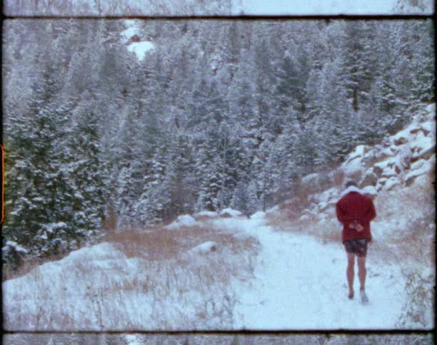 A man is hiking outdoors in winter