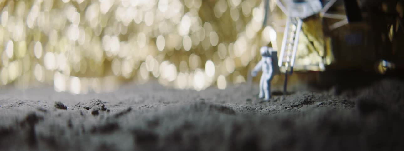A close up view of an astronaut statue on some rocks