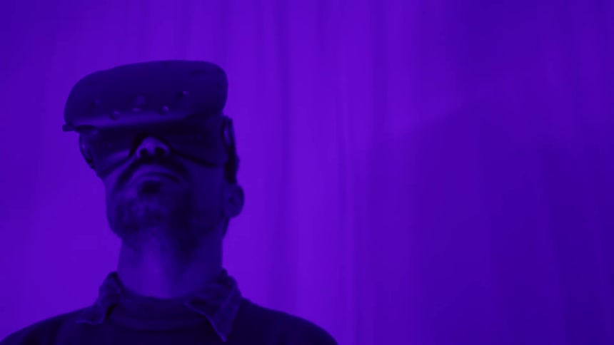 A man is wearing a virtual reality headset