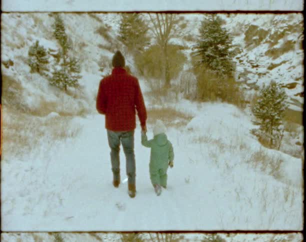 A father and child hike in the snow