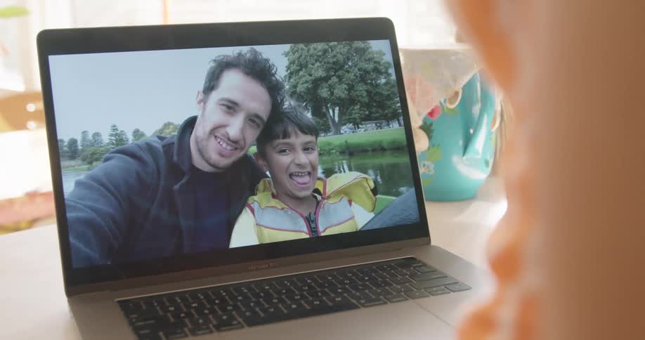 Two people talking on a laptop