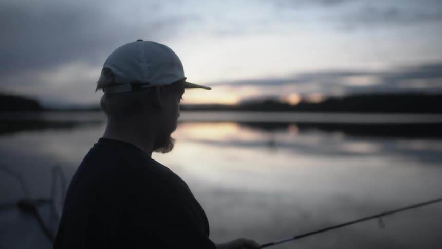 A bearded man casts his fishing line