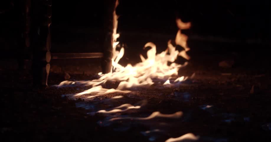 A piece of furniture on fire burning with flames and smoke