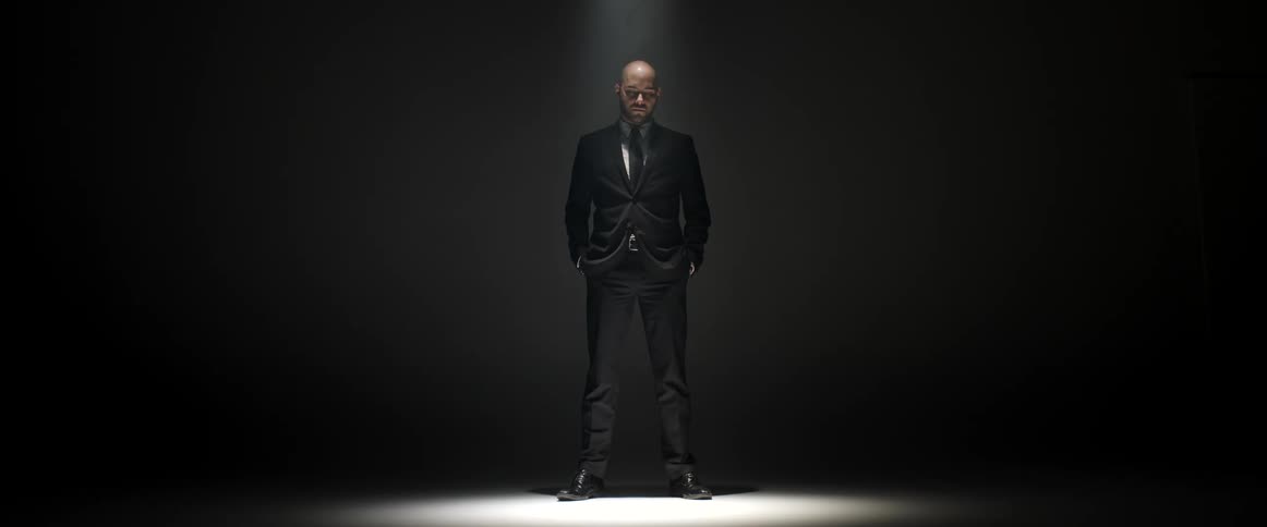 A man standing under a spotlight