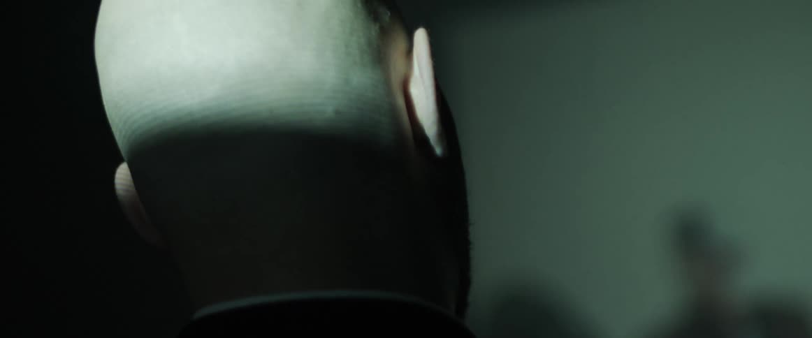 A man in a room with a projector projecting an image on a wall