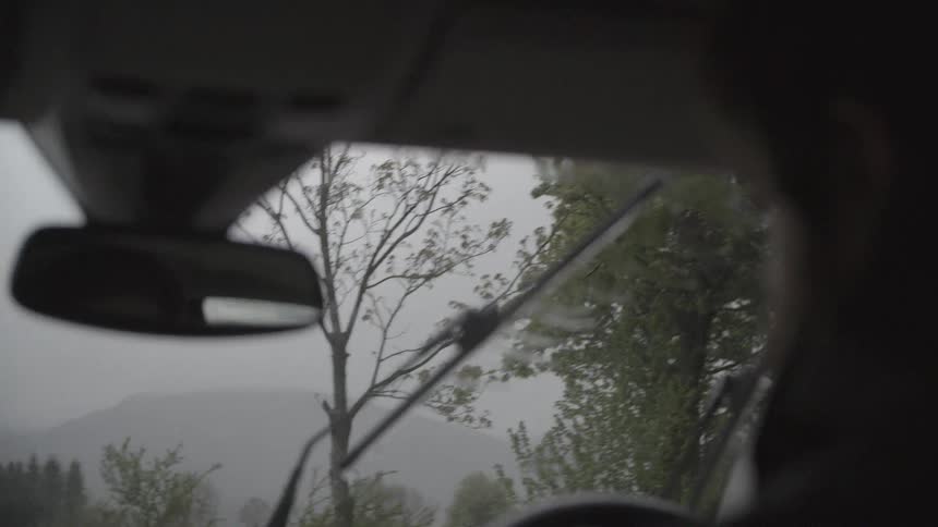 Rain falls on a windshield