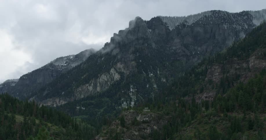 Clouds floating above a mountain range in the daytime