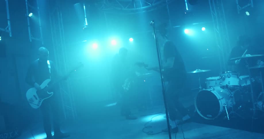A band is performing at a concert on stage