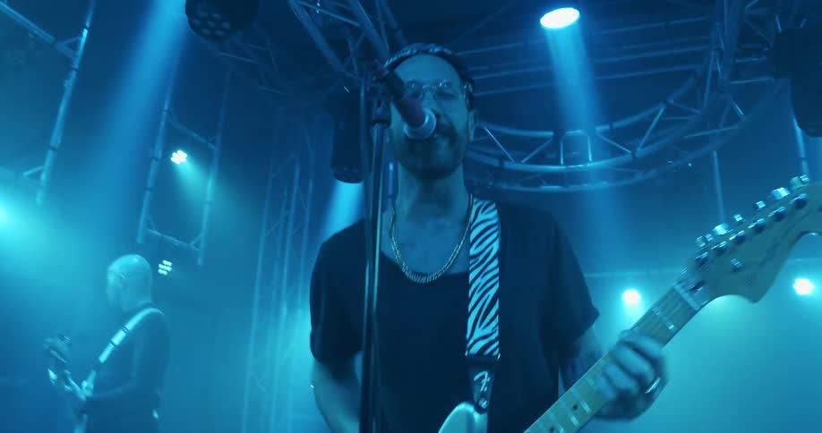 A man playing guitar on a stage