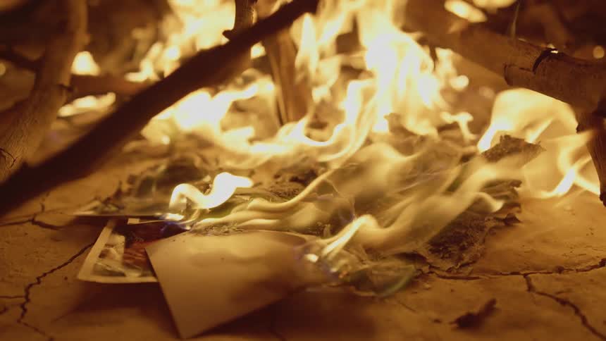 A campfire is burning and full of sticks
