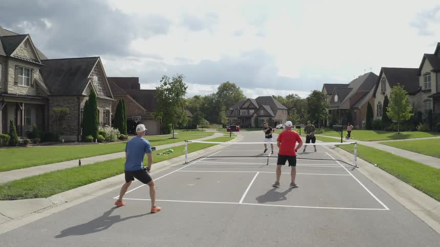 A group of people playing pickleball together
