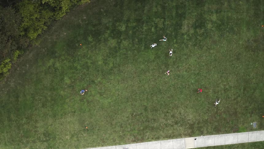 A group of people playing football in an open field