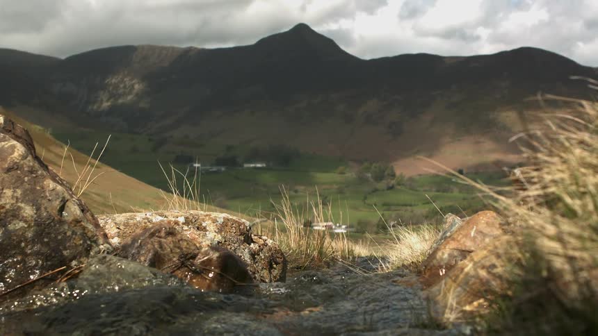 A stream rushing through hilly land