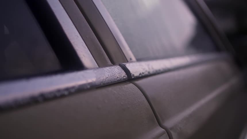 A car's side windows, covered with moisture