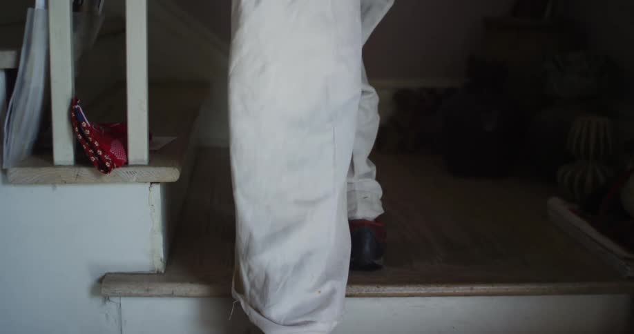A person climbs the steps in their home