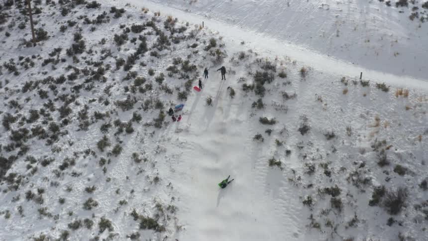 A person falling off a snowboard in a snowy slope