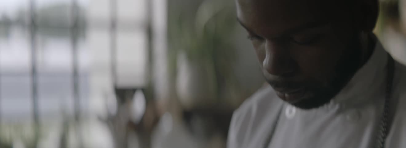 A man looks down and concentrates
