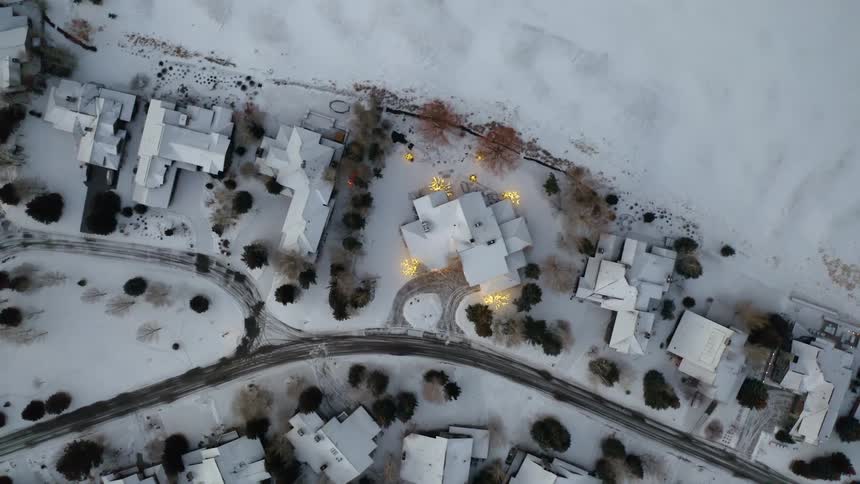 Aerial view of houses in a small town covered in white snow at winter