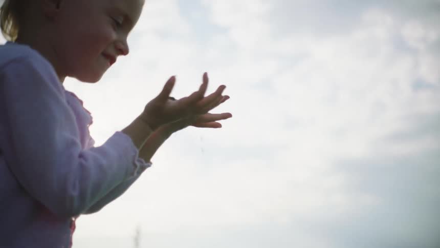 A child playing with dirt at a farm