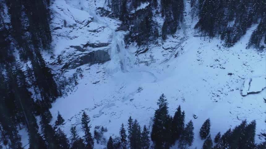 A water fall rushing down a cliff in a forest