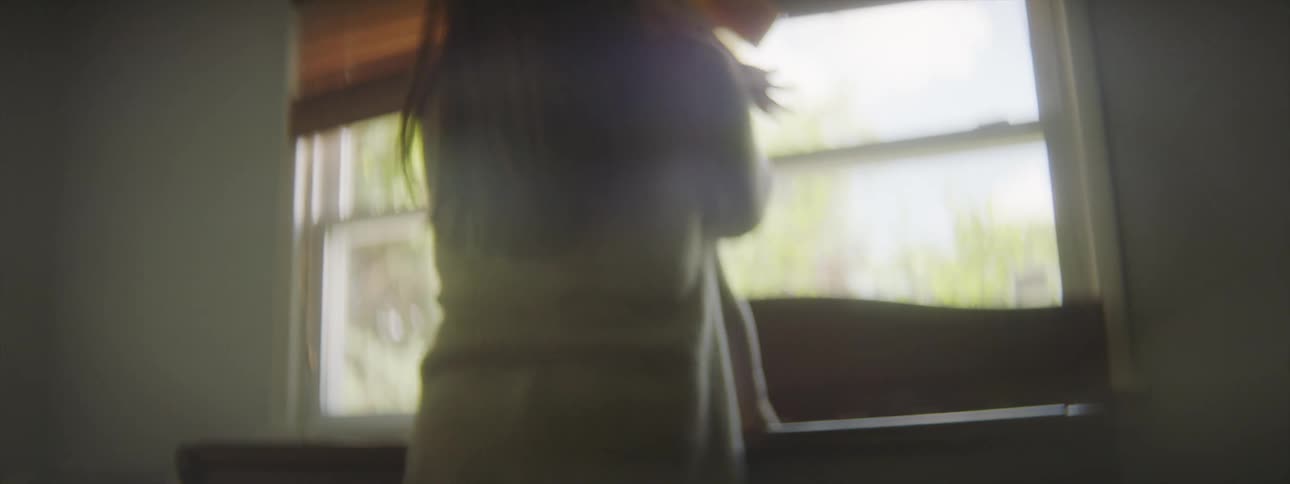Mother bends over a crib at home to take the baby out in her arms