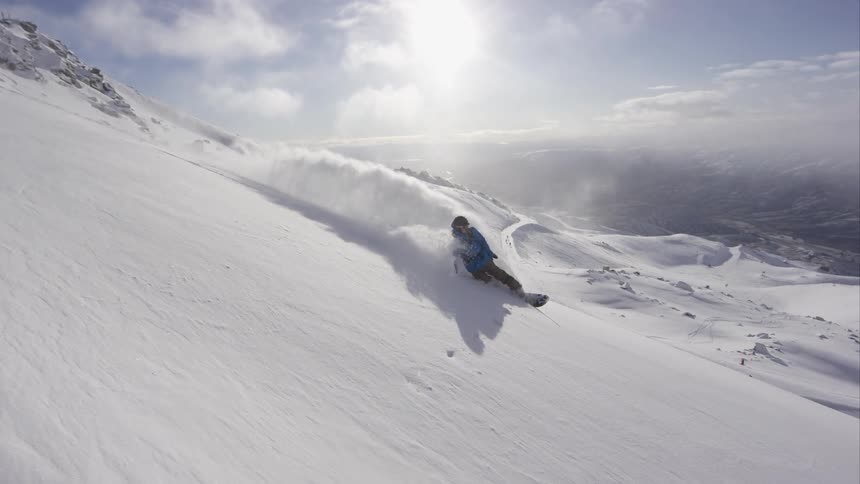 A man snowboarding on a clear day