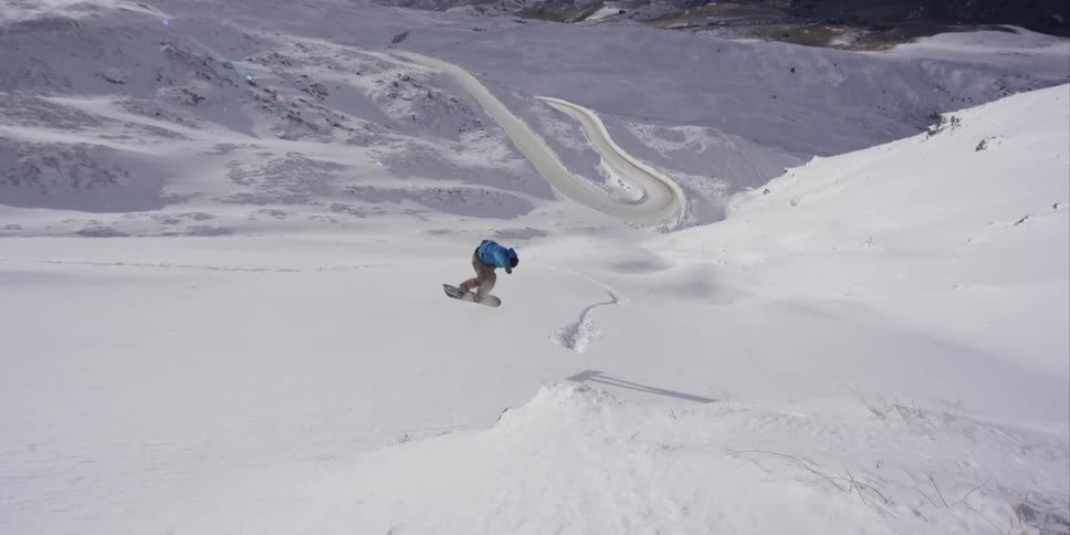 A man snowboarding on a clear day