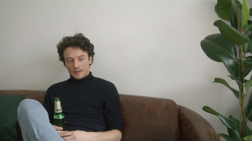 Man drinking beer thinking