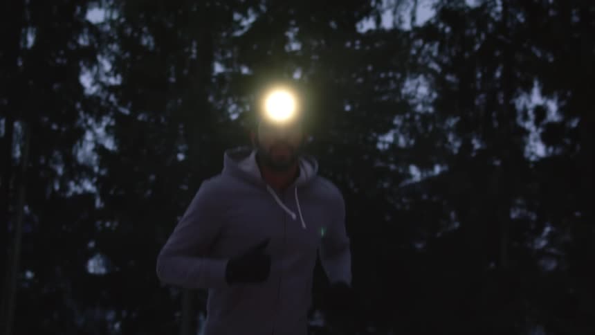 A man is jogging at sunset