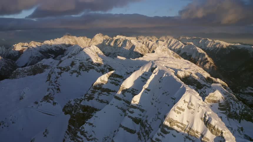 Snow covered mountain range on a cloudy day