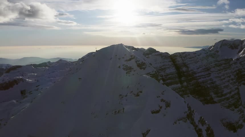 A flag on top of a mountain range