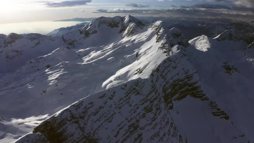 Snow covered mountain range on a cloudy day