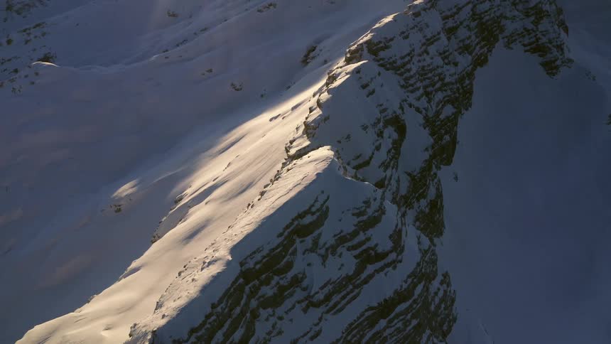 An aerial view of a snow covered mountain range