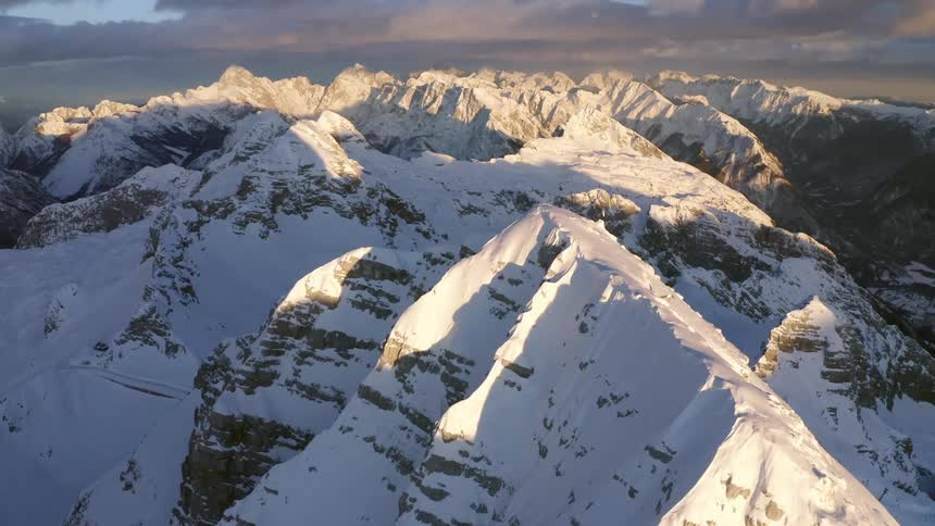 Snow covered mountain range on a cloudy day