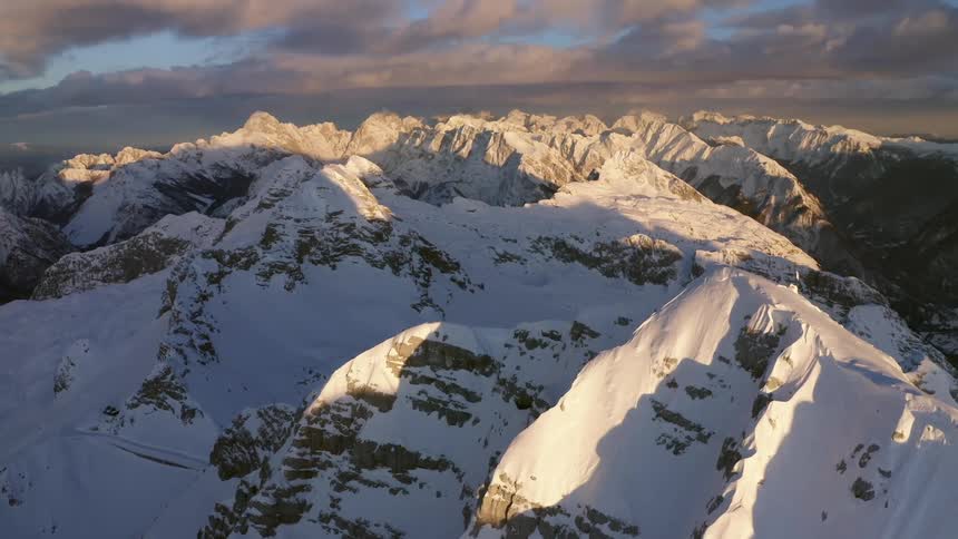 Snow covered mountain range on a cloudy day