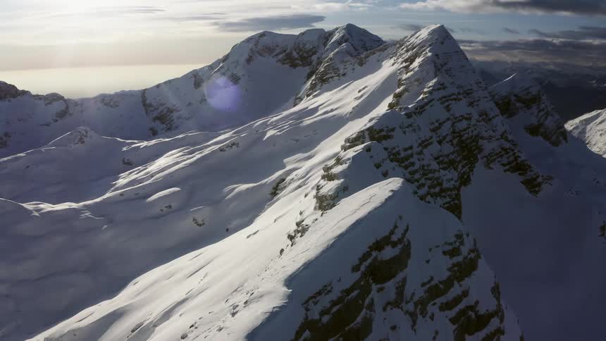 Snow covered mountain range on a cloudy day