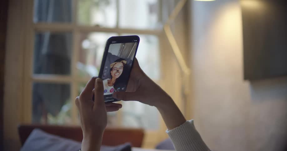 A woman taking a photo on a smartphone