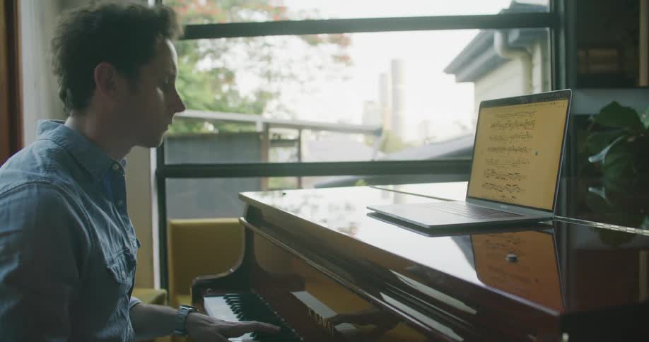 A man is playing the piano indoors