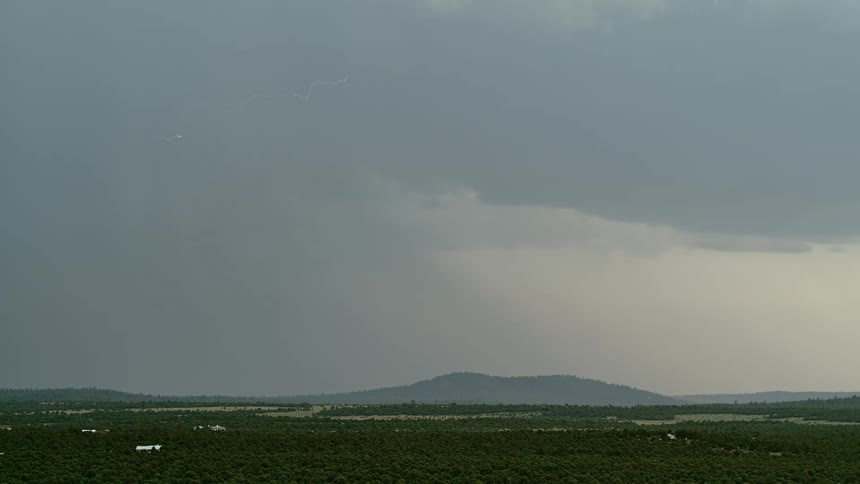 Lightning bolts flash and branch out over mountains