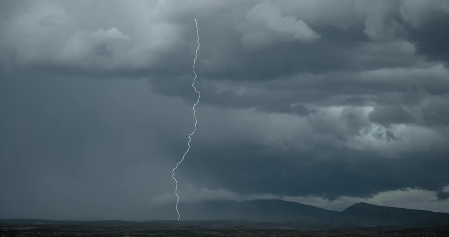 Lightning bolt from storm cloud hits the ground