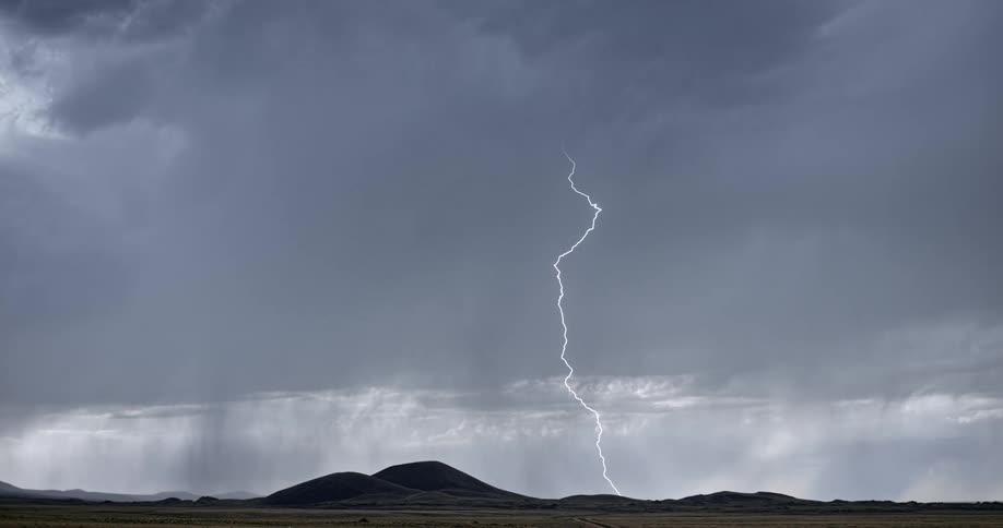 Lightning flashes from rain clouds during a thunderstorm