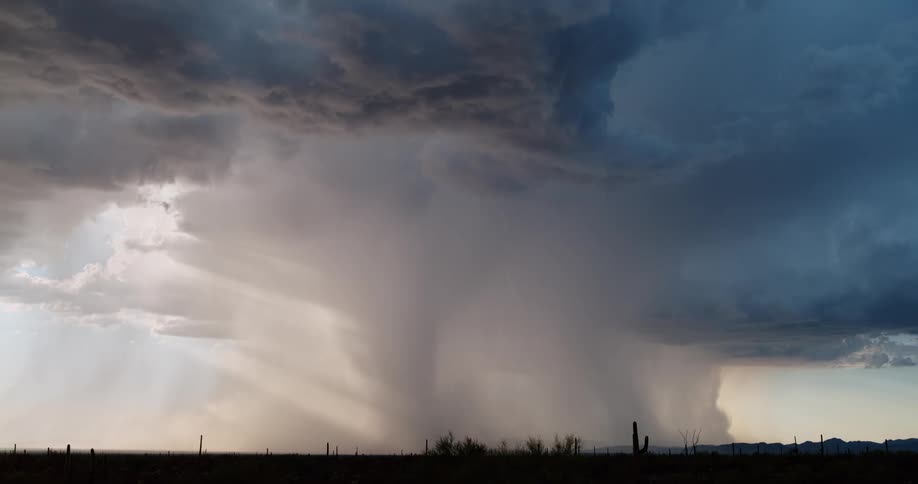 Lightning flashes around a pillar of clouds extending from the ground up to the sky filled with thick clouds