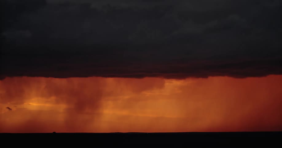 A storm with lightning over a landscape with the sky and clouds in the background