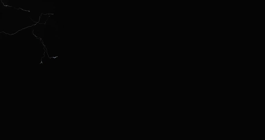 A flash of lightning crosses the night sky