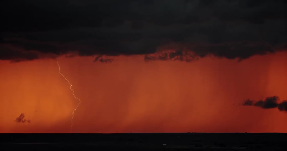 A landscape with a storm with lightning in the sky and clouds in the background