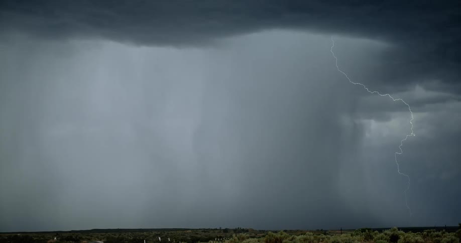 Lightning bolt from a storm cloud hits the ground