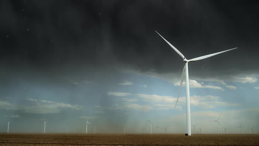 A landscape with a wind turbine farm with the sky and clouds in the background