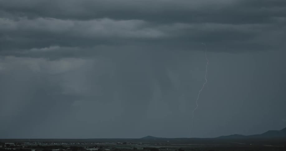 Lightning bolt from storm cloud hits the ground