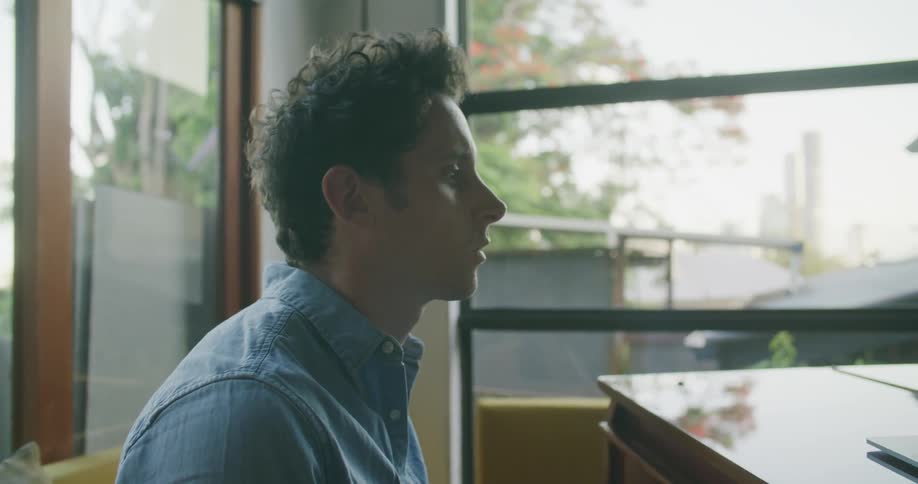 A man is reading music and playing the piano