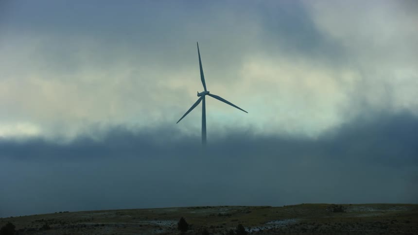 Low altitude clouds make it look like this windmill is rising out of the clouds to generate clean renewable energy out of thin air